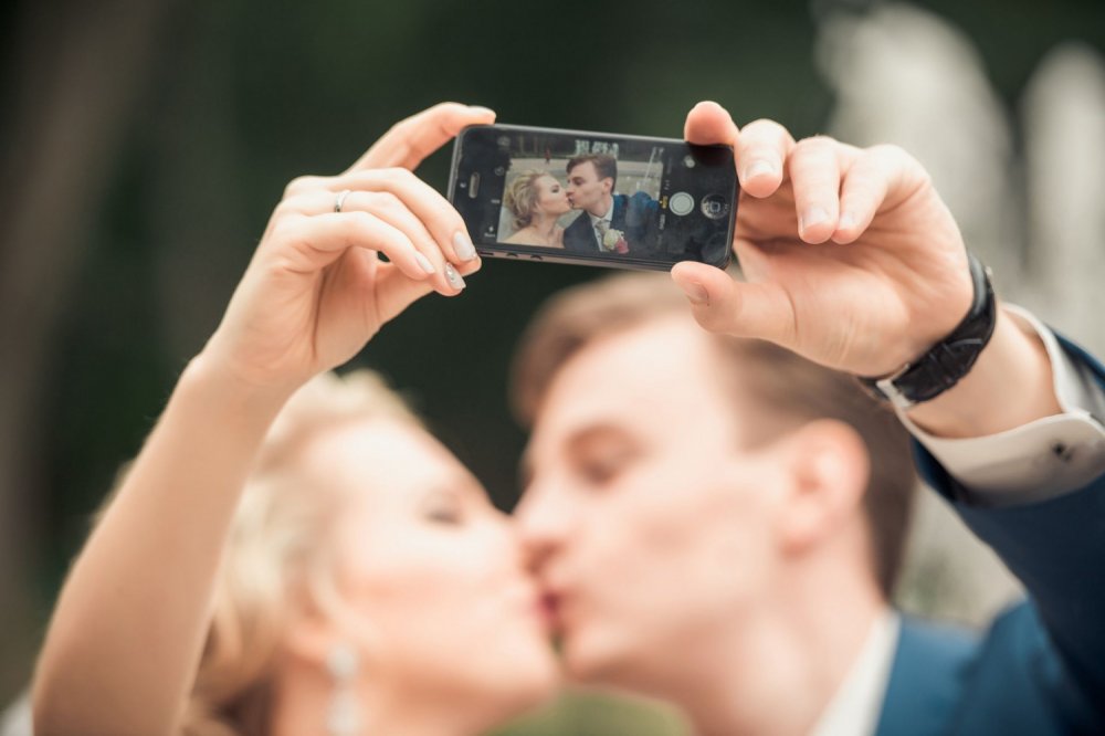 Фото целующихся молодоженов через телефон